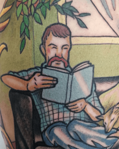 tatuaje retrato neotradicional hombre con bigote leyendo un libro en un sillón - 200